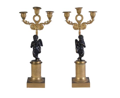  A pair of Empire gilt and patinated bronze three light figural candelabra,   early 19th century, each with an anthemia cast 