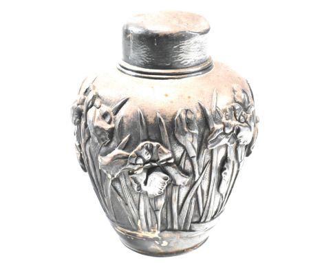 A Japanese silver tea caddy. The caddy having repousse iris decoration with inner lid and stopper. Japanese marks to base. To
