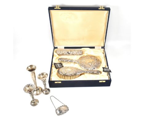 A hallmarked silver dressing set together with a hallmarked gin decanter label and three AF silver bud vases. The dressing se