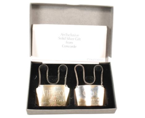 A pair of hallmarked silver decanter labels for Whiskey and Gin. The labels hallmarked for Birmingham 1986 Sponsor mark BA. C