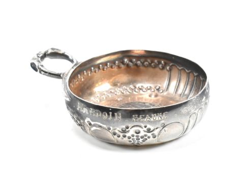 A French silver taste-vin. The tastevin with snake handle decorated with a central image Louis XVI in the shape of a coin and