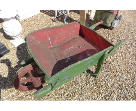 A vintage wooden painted wheel barrow, ideal for planting out 