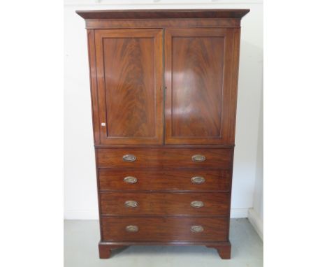 A 19th century mahogany linen press with three internal slides above four drawers, on bracket feet, in nice condition - 220cm