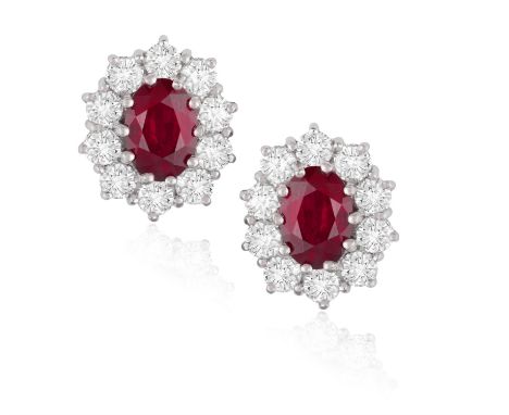 A PAIR OF RUBY AND DIAMOND EARSTUDSEach stud of cluster design, set with an oval-shaped ruby, framed by brilliant-cut diamond