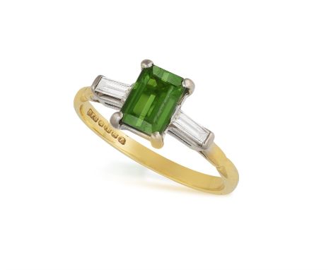 A TOURMALINE AND DIAMOND RINGClaw-set with a rectangular-shaped green tourmaline, flanked by baguette-cut diamonds, mounted i