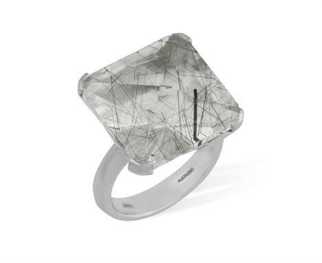 A RUTILE QUARTZ RINGClaw-set with a faceted square-shaped rutilated quartz, displaying black rutile needle inclusions, to a t