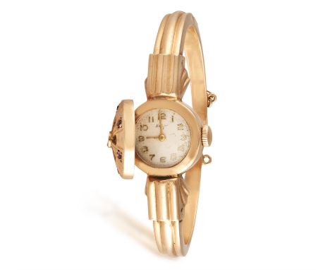 A LADY'S RETRO RUBY COCKTAIL WATCH, CIRCA 1950Of manual wind movement,  the circular case highlighted with circular-cut rubie