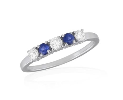 A SAPPHIRE AND DIAMOND RINGThe frontispiece set with two circular-cut sapphire, between brilliant-cut diamonds, mounted in 18