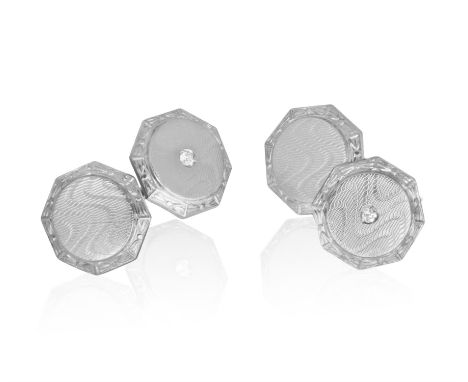A PAIR OF DIAMOND CUFFLINKSEach octagonal textured plaque, two set with a brilliant-cut diamond at the centre, mounted in 14K