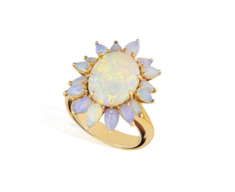 AN OPAL RINGClaw-set with an oval-shaped opal cabochon, within a surround of pear-shaped opal cabochon, mounted in 18K gold, 