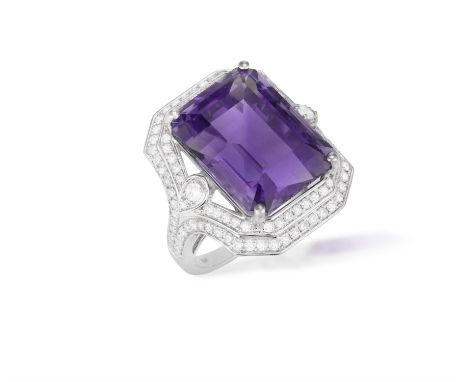 AN AMETHYST AND DIAMOND RINGSet with a rectangular-cut amethyst weighing approximately 16.00cts, within a double-border surro