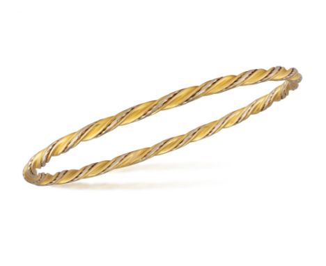 A GOLD BANGLE The ridged bangle of bi-coloured twisted wire design, in 18K gold, inner circumference 19.5cm Condition Report:
