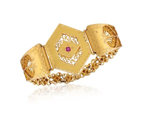A GOLD BRACELETThe engraved hexagonal-shaped central plaque, with lozenge-shape motif, enhanced with a circular-shaped possib
