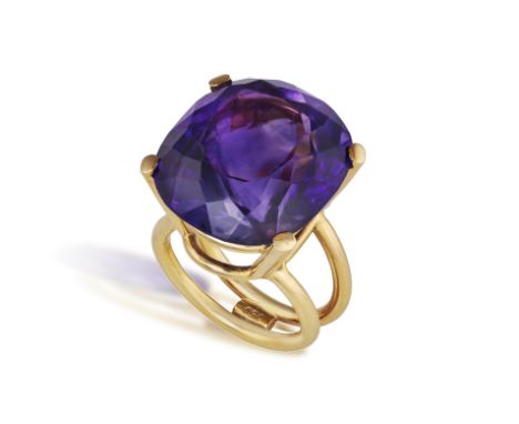 AN AMETHYST COCKTAIL RINGThe cushion-shaped amethyst weighing approximately 32.00cts, between a four-claw setting, mounted in