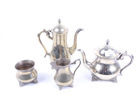 A Middle Eastern silver plated and brass four piece tea and coffee service. Comprising a teapot, coffee pot, cream jug and su