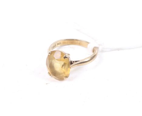 A vintage oval citrine single stone ring. The oval mixed-cut stone claw set on a D-section shank stamped '9ct', size L, 3.2g 