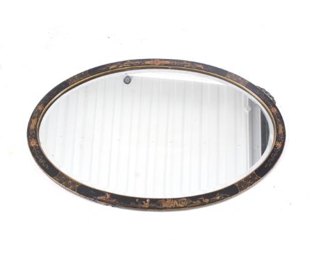 An early 20th century bevelled edge Chinoiserie wall mirror. Of oval form, the black lacquer frame decorated with flowers, sc