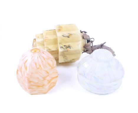 A collection of three assorted mid-century glass ceiling lamp shades. Mottled polychrome decorated pattern with shaped glass.