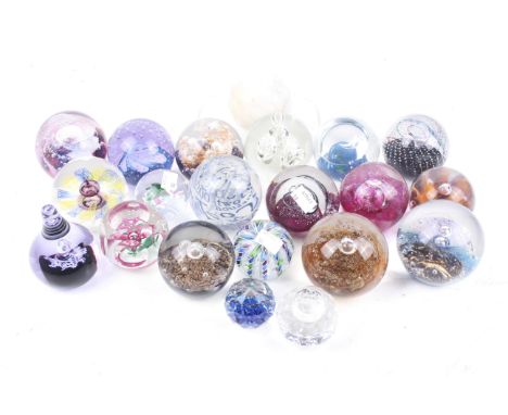 A collection of glass paperweights. The majority are Scottish examples including Caithness and Selkirkglass, etc.