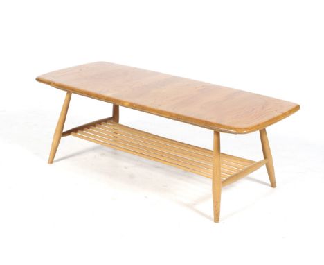 A mid-century Ercol elm and beech coffee table. With open spindle undershelf, four turned tapering supports. L104cm x D46cm x