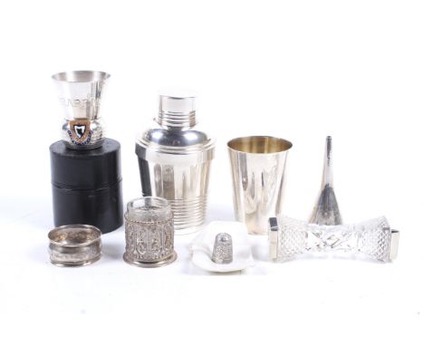 A group of silver and white metal collectables. Including a dinky cocktail shaker, H11cm, three cups, a napkin ring, funnel a