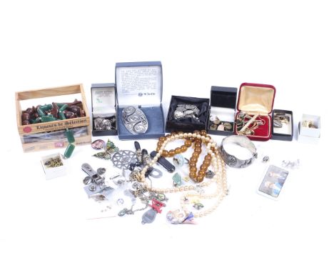 An assortment of costume and other jewellery. Including a silver padlock, a pair of silver cufflinks with engine turned decor