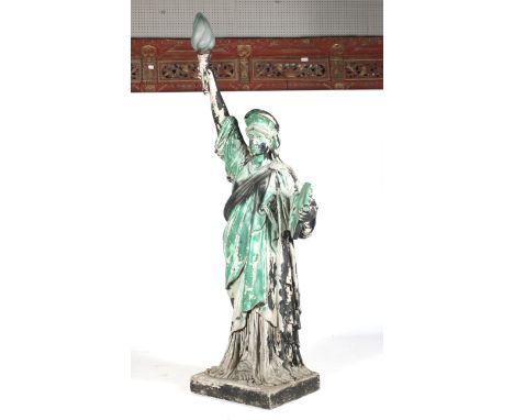 A 21st century Urban Art 'Statue of Liberty' lamp. The fibreglass 2.5m high cast model with a glass flame shade, spray painte