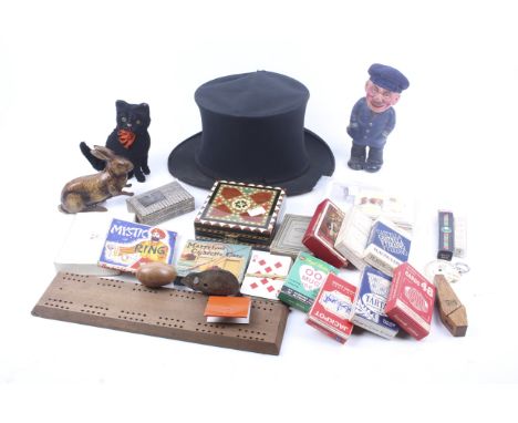 An assortment of vintage toys and novelties. Including a clockwork tinplate rabbit, a Schuco clockwork mouse, sets of playing