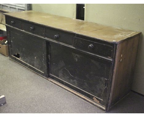 A large Edwardian ebonised shop storage counter. Linolium nailed to the top, four drawers with large turned handles above two