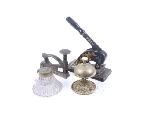 Four Edwardian desk office items. Comprising a desk bell, inkwell and two embossing stamps, Max. H22cm
