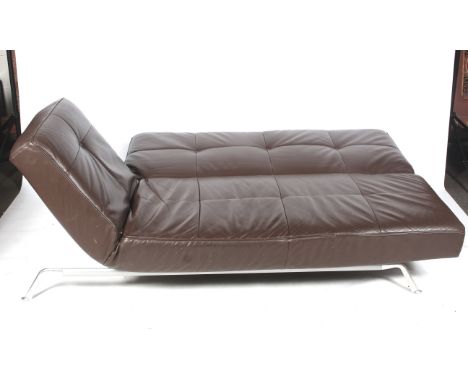 A Ligne Roset Smala brown leather sofa bed. Raised on metal support. With manual drop/raise back and arm. Bed size L215cm x D