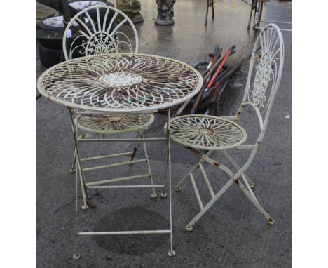 A vintage metal framed garden furniture set of a circular table and two chairs. Painted light green, table, H75cm x Diameter 