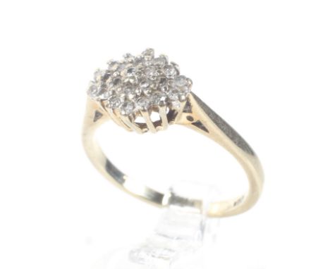 A modern 9ct gold and diamond cluster ring. The 23 round brilliant cut stones circa 0.25cts total, post-2000 Sheffield conven