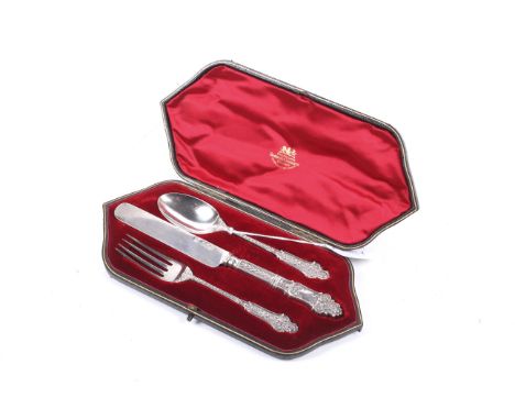 A late Victorian silver christening knife, fork and spoon set. With shaped handles and embossed decoration, hallmarks for The