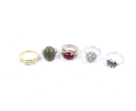 Five gem-set silver and white metal rings. Comprising an oval carnelian cabochon single stone ring, size P; a paste bombe clu