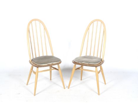 A pair of Ercol Windsor stick-back dining chairs with upholstered seat cushions. Blonde elm, gold label #365, H97cm.  Conditi