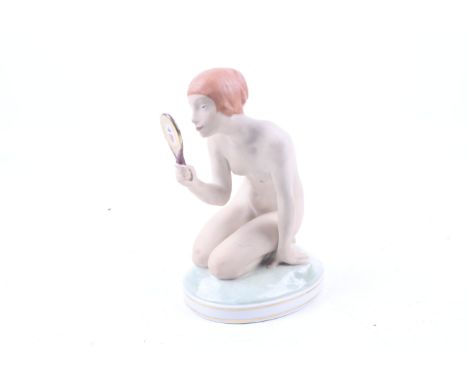 A Royal Copenhagen Gerhard Henning porcelain figure. Modelled as a kneeling female nude holding a mirror to her face, H18cm. 