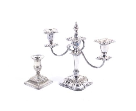 A late Victorian weighted silver candlestick and a silver-plated two-branch three-light candelabrum. The short square based c
