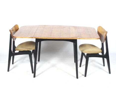 Circa 1950s E Gomme G-Plan Librenza Tola drop leaf table and two 'Butterfly' chairs. Mahogany top with black painted legs, ex