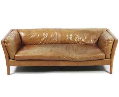 A contemporary John Lewis Scandinavian style tan leather three-seater sofa. Raised on tapering supports, L187cm x D79cm x H65