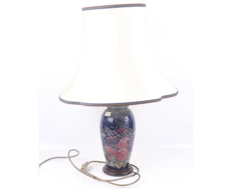 A Moorcroft table lamp and shade. Blue Finches pattern designed by Sally Tuffin, with tube lined finch birds with fruit and b