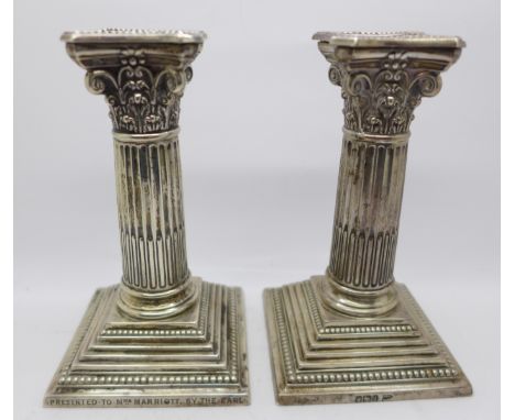 A pair of silver candlesticks by Walker &amp; Hall, with fox hunting inscription dated 1905, with weighted bases, 15cm