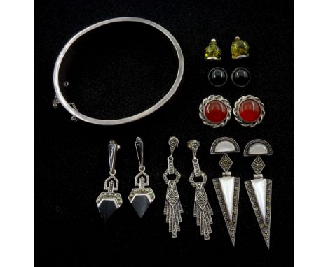 Six pairs of silver stone set stud earrings including black onyx and marcasite, amber, mother of pearl and marcasite and agat