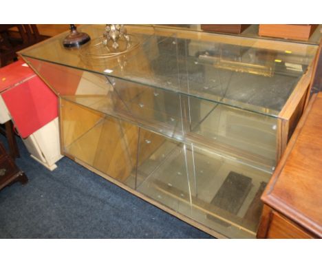 A VINTAGE SHOP DISPLAY CABINET WITH ANGULAR FRONT