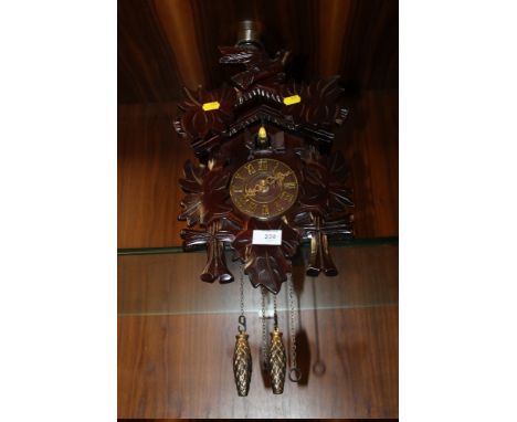 A CARVED WOODEN CUCKOO CLOCK
