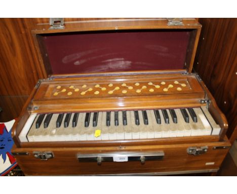 A CASED VINTAGE ACCORDIAN