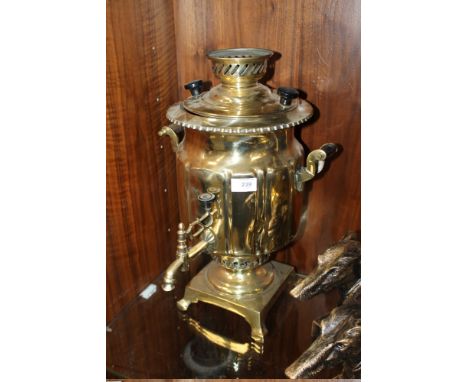 A VINTAGE BRASS OIL BURNING WATER HEATER