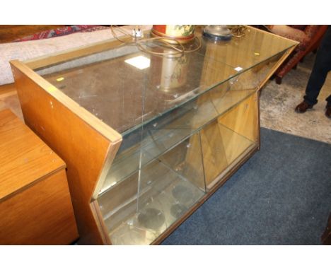 A VINTAGE SHOP DISPLAY CABINET WITH ANGULAR
