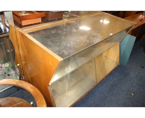 A VINTAGE SHOP DISPLAY CABINET WITH ANGULAR FRONT