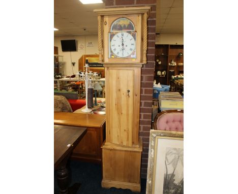 A PINE CASED LONGCASE CLOCK WITH ENAMEL & PAINTED FACE